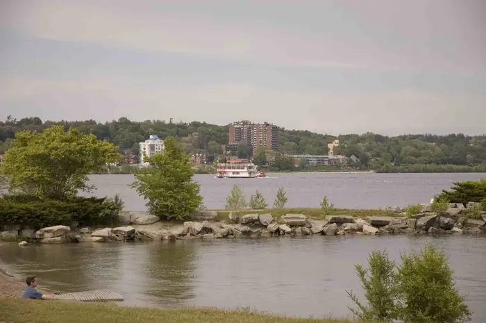 Grass and rocks along the shore at Centennial Park, looking across Kempenfelt Bay in Barrie
