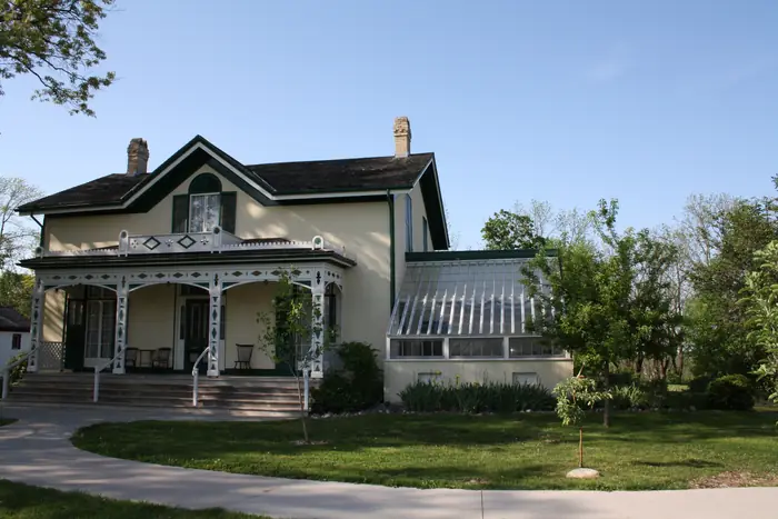 The Bell Homestead house with a curved path and trim lawn, a yard the best landscaper in Brantford would be proud of