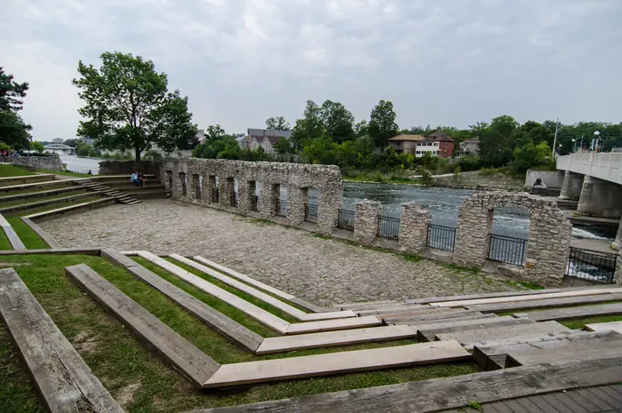 Grass terraces and old stone walls at Mill Race Park beside the Grand River in Galt