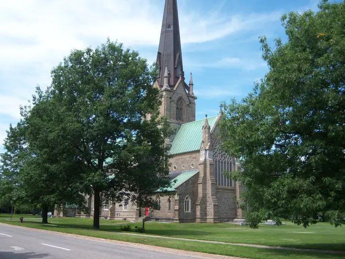Mowed lawn and old trees at Christ Church Cathedral, the kind of yard people hire the best landscaper in Fredericton for