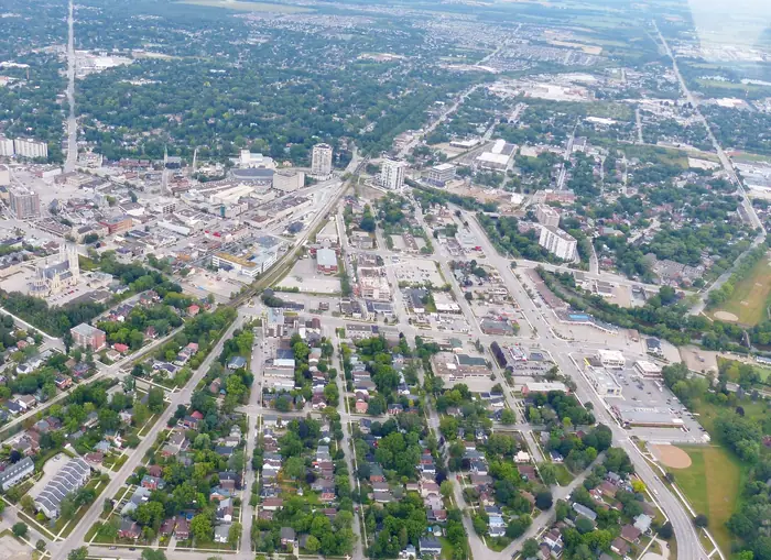 Downtown Guelph from the air, with tree-lined streets and backyards spreading out from the core