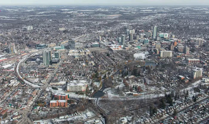 Downtown Kitchener and Victoria Park from the air in December, full of yards that will need the best landscaper in Kitchener come spring