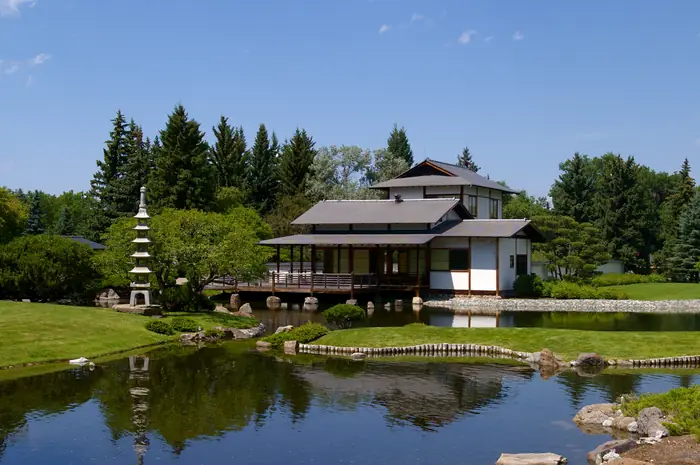 Japanese garden house beside a pond and a smooth mowed lawn at Nikka Yuko, the kind of neat lawn people want the best landscaper in Lethbridge for