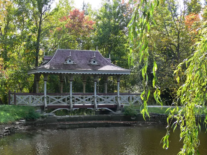 The Pagoda Bridge over the pond in Jackson Park, Peterborough, with grass banks and willows