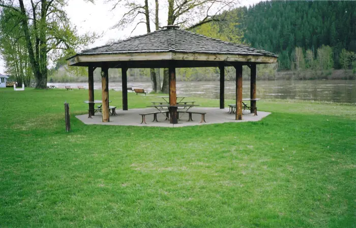 Mowed green lawn and a wooden gazebo by the river at Paddlewheel Park, the kind of grass people want from the best landscaper in Prince George