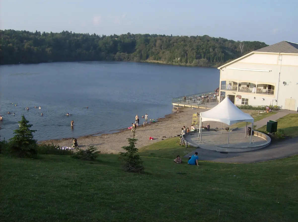 Grassy slope down to the beach at Lily Lake in Rockwood Park, Saint John