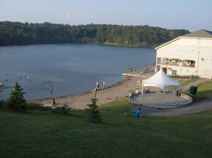 Grassy slope down to the beach at Lily Lake in Rockwood Park, the kind of lawn people hire the best landscaper in Saint John for