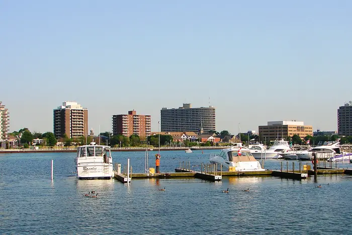 Downtown Sarnia towers behind a marina, in the city where homeowners look for the best landscaper in Sarnia
