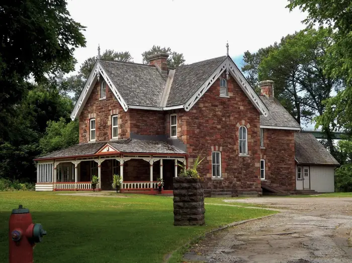 Stone house and wide front lawn at the Sault Canal, the kind of yard people call the best landscaper in Sault Ste. Marie for