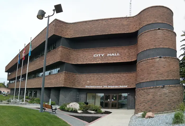 Spruce Grove City Hall with a mowed lawn and garden beds, the tidy look people want from the best landscaper in Spruce Grove