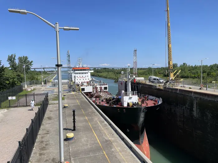 A lake freighter easing into Lock 3 of the Welland Canal in St. Catharines on a clear summer day