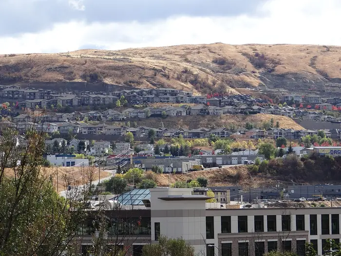 Rows of homes climbing a dry, grassy hillside in Vernon