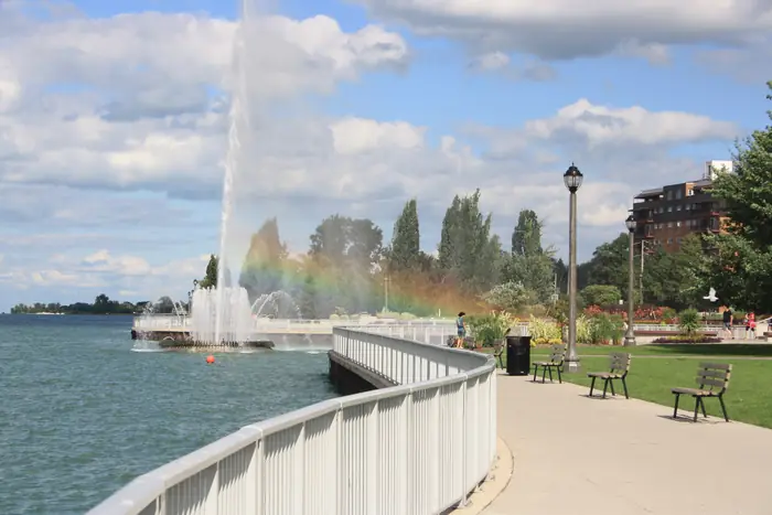 The old Peace Fountain spraying in the Detroit River beside the lawns of Coventry Gardens on Riverside Drive